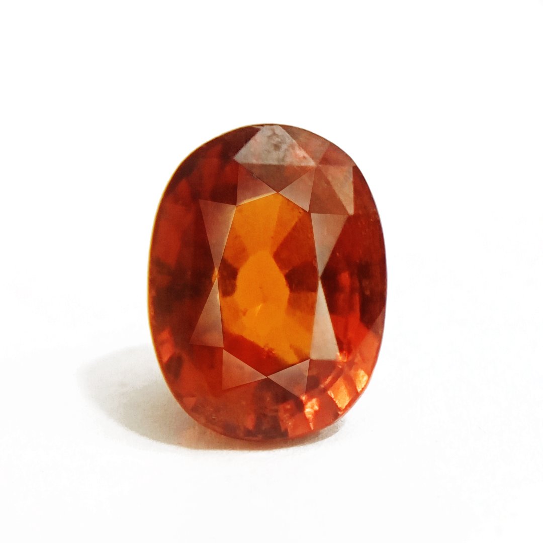 A close-up of a Natural African Gomedh (Hessonite Garnet) gemstone with a deep reddish-brown hue and radiant clarity.