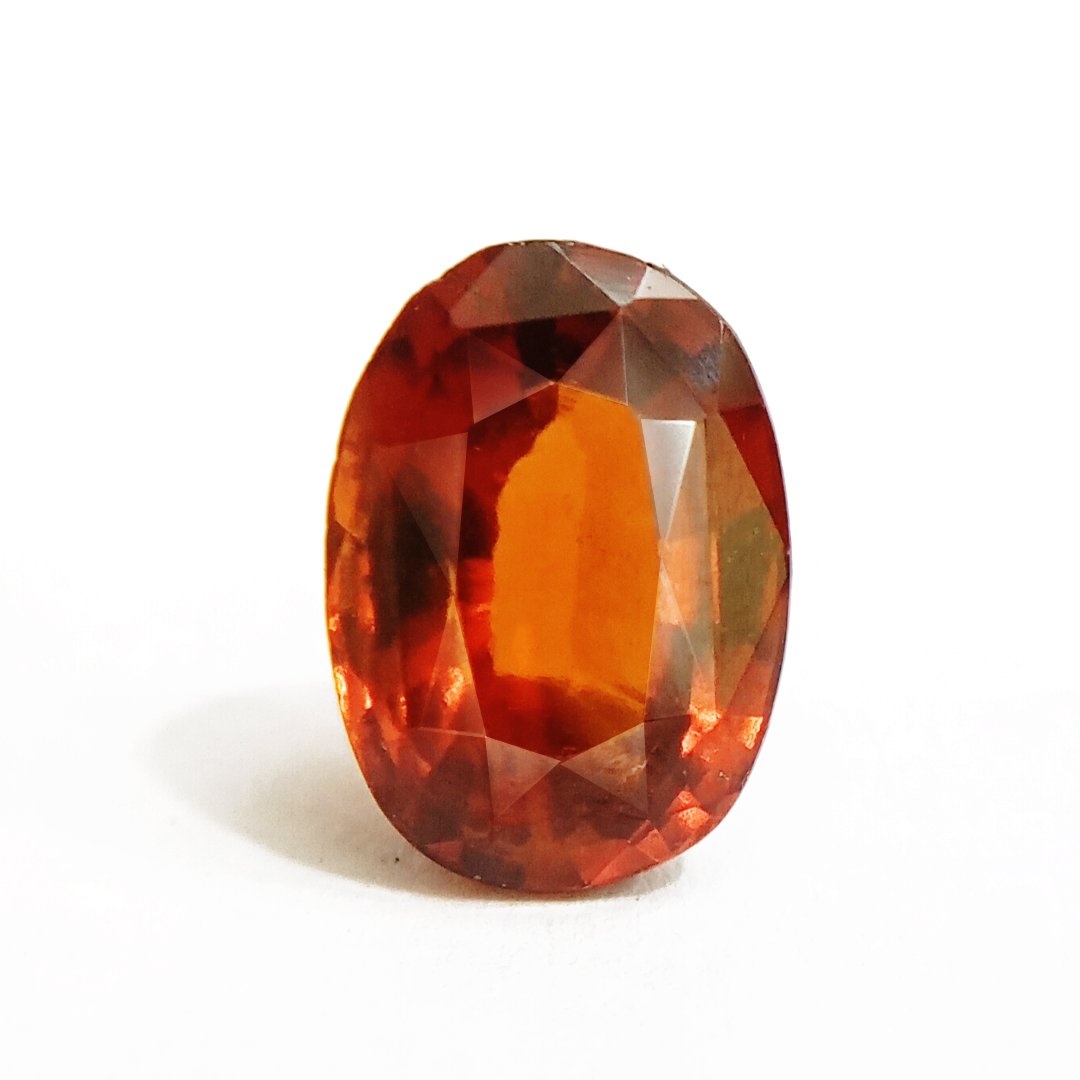 A close-up of a Natural African Gomedh (Hessonite Garnet) gemstone with a deep reddish-brown hue and radiant clarity.