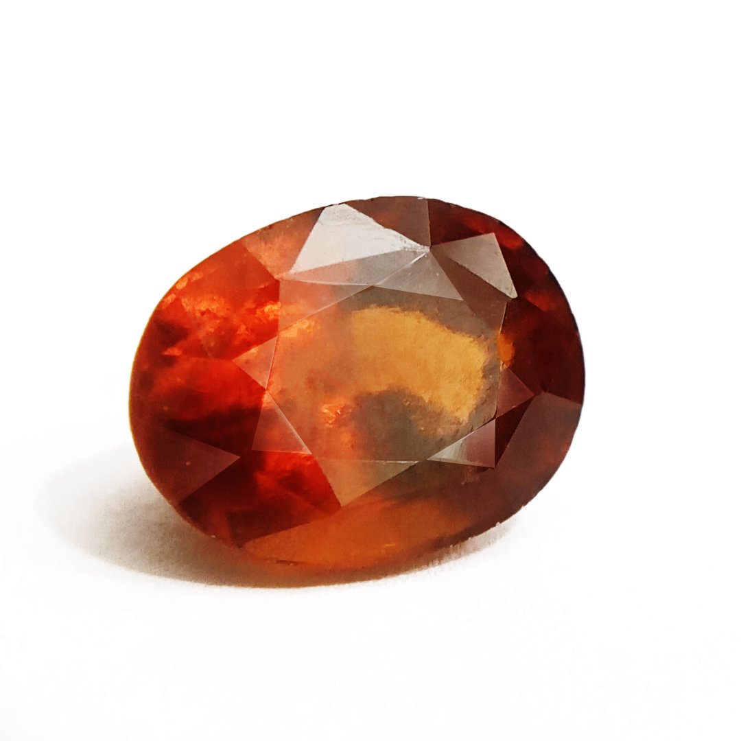 A close-up of a Natural African Gomedh (Hessonite Garnet) gemstone with a deep reddish-brown hue and radiant clarity.