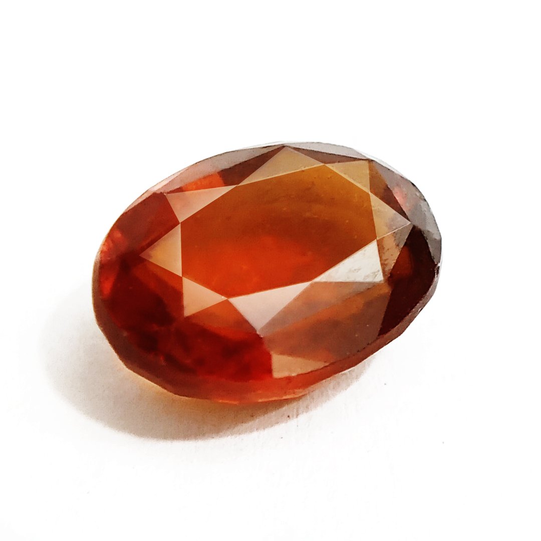 A close-up of a Natural African Gomedh (Hessonite Garnet) gemstone with a deep reddish-brown hue and radiant clarity.