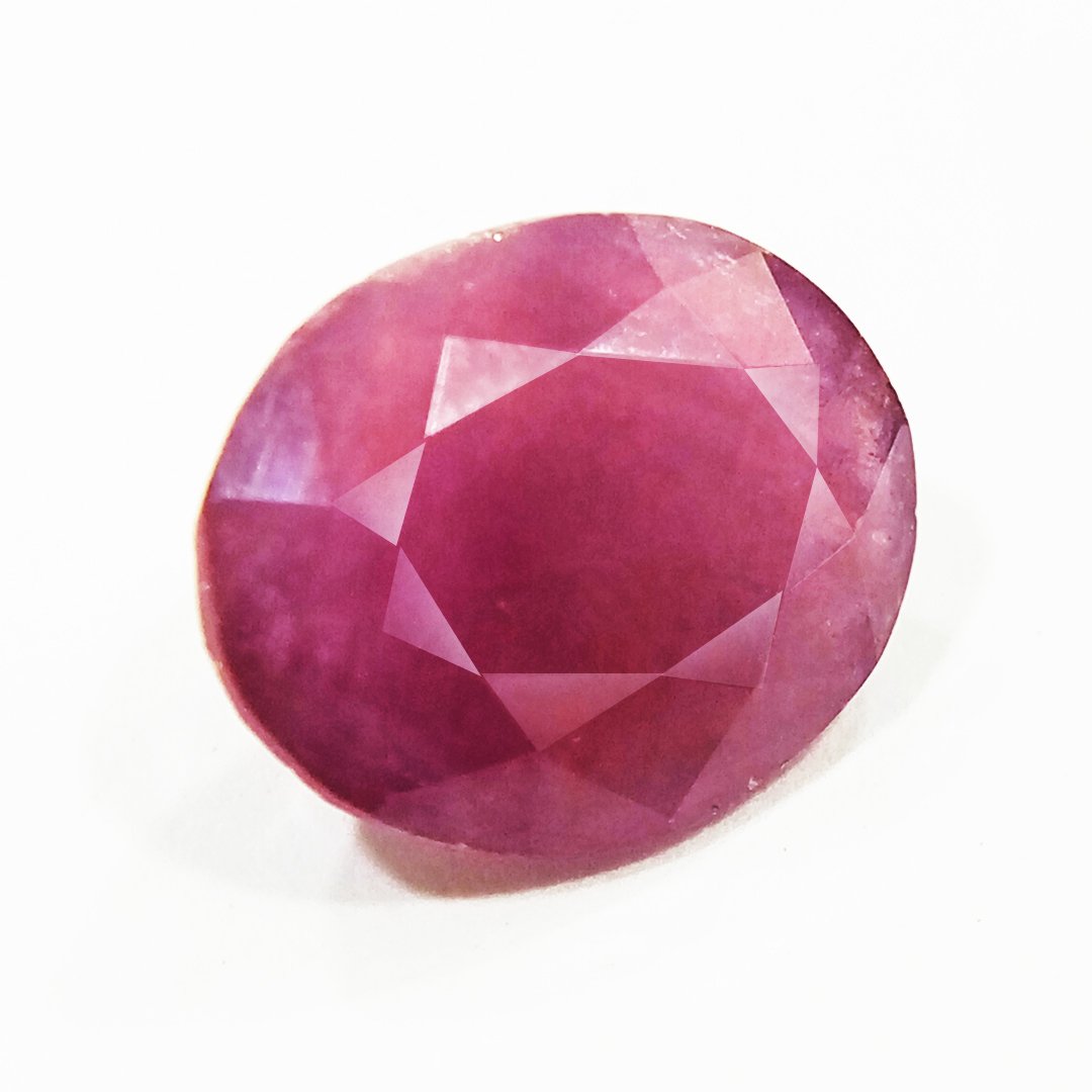 A close-up of a Natural African Ruby gemstone showcasing its rich red hue and brilliant clarity.