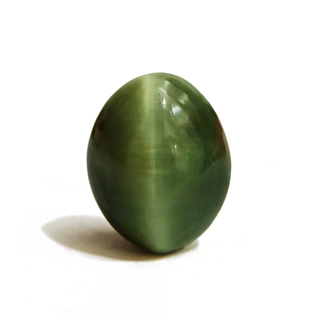 Mystical Indian Cat's Eye gemstone with a striking chatoyant effect, symbolizing protection, insight, and prosperity.