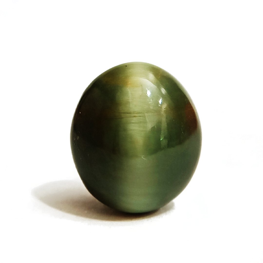 Mystical Indian Cat's Eye gemstone with a striking chatoyant effect, symbolizing protection, insight, and prosperity.