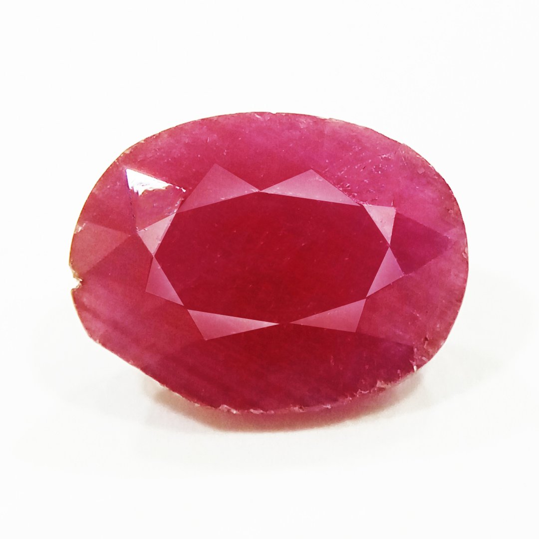 A close-up of a Natural African Ruby gemstone showcasing its rich red hue and brilliant clarity.