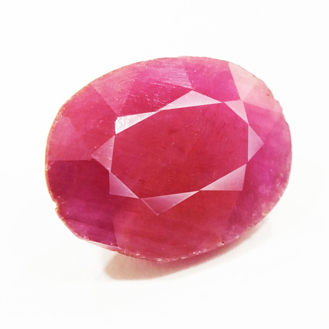 A close-up of a Natural African Ruby gemstone showcasing its rich red hue and brilliant clarity.