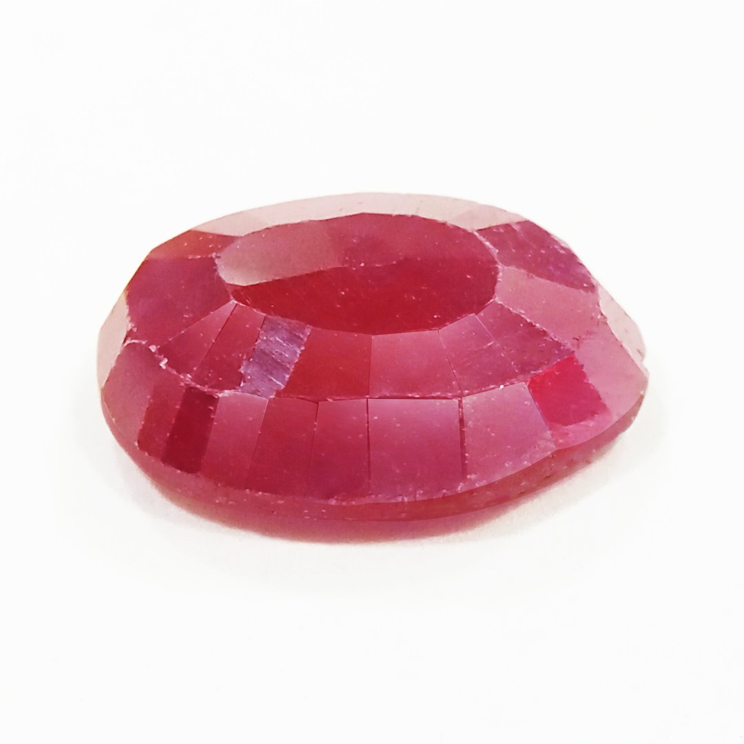 A close-up of a Natural African Ruby gemstone showcasing its rich red hue and brilliant clarity.