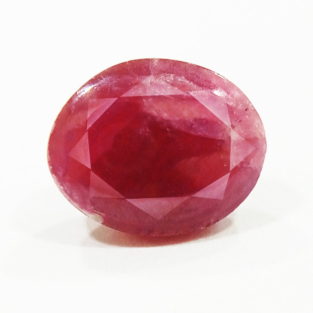 A close-up of a Premium Indian Ruby gemstone showcasing its deep red hue and exceptional clarity.