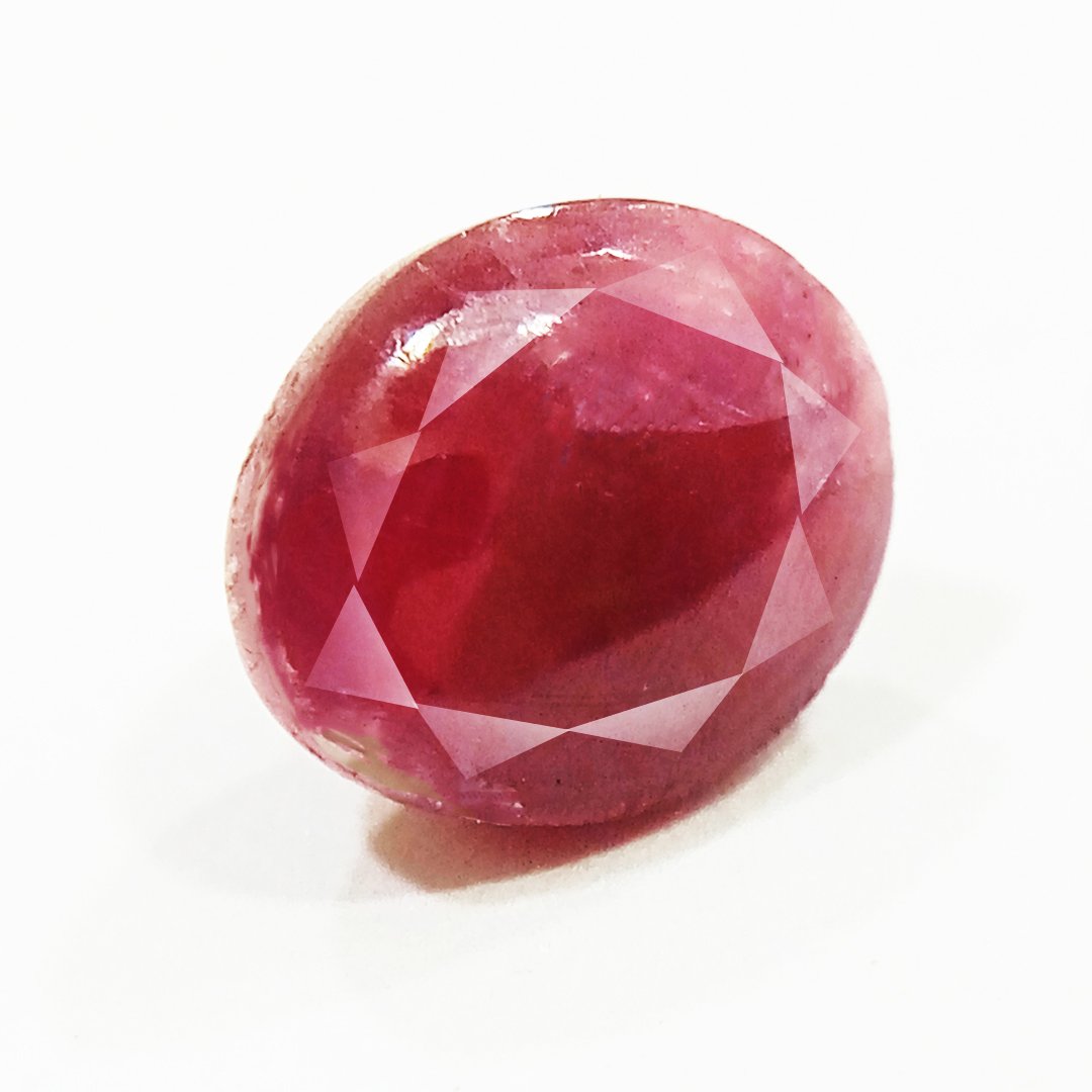 A close-up of a Premium Indian Ruby gemstone showcasing its deep red hue and exceptional clarity.