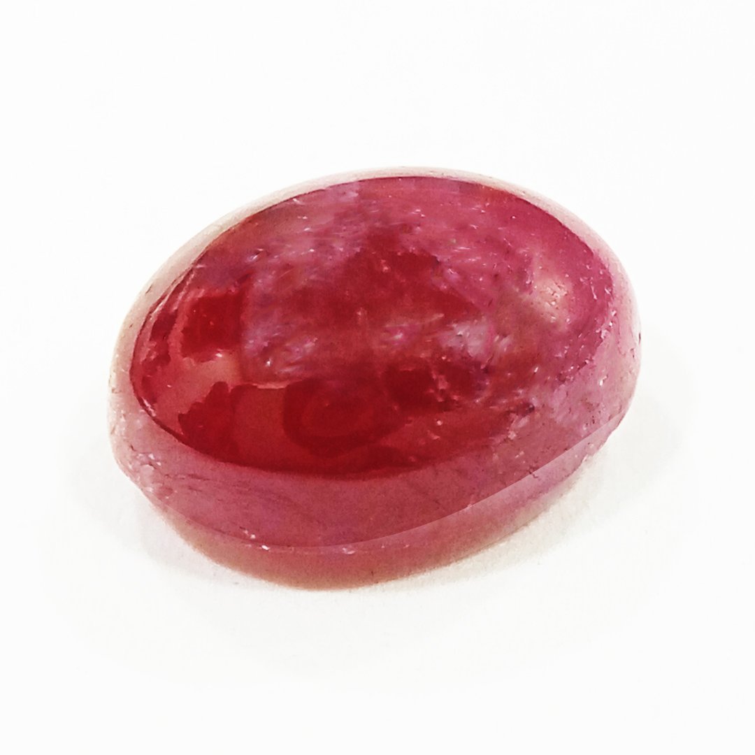 A close-up of a Premium Indian Ruby gemstone showcasing its deep red hue and exceptional clarity.