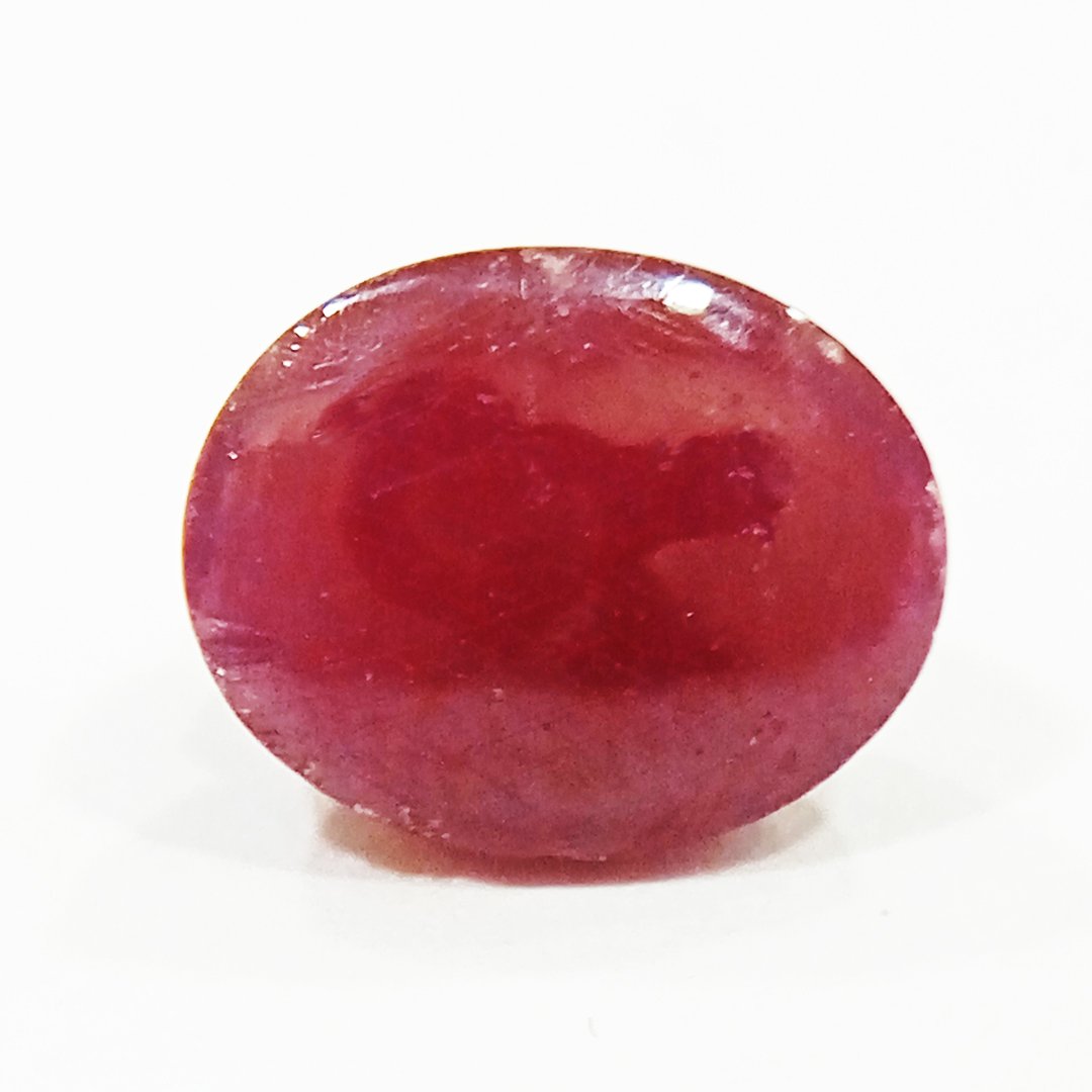 A close-up of a Premium Indian Ruby gemstone showcasing its deep red hue and exceptional clarity.