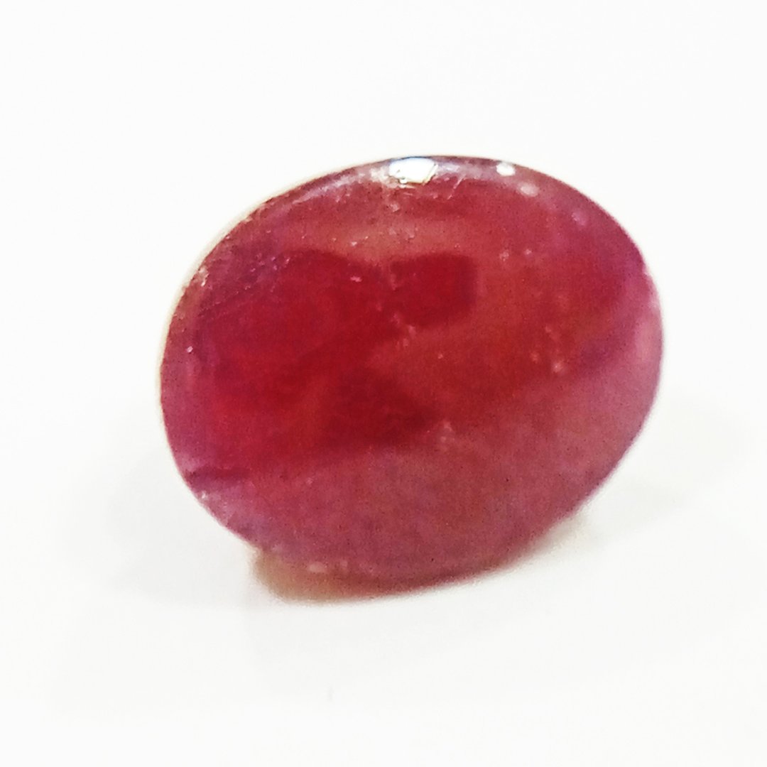 A close-up of a Premium Indian Ruby gemstone showcasing its deep red hue and exceptional clarity.