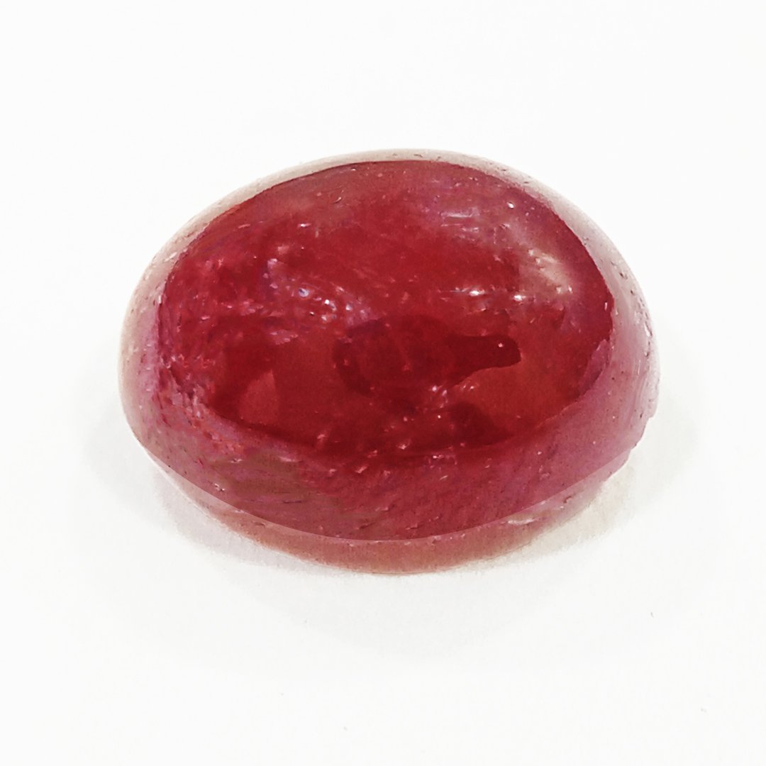 A close-up of a Premium Indian Ruby gemstone showcasing its deep red hue and exceptional clarity.
