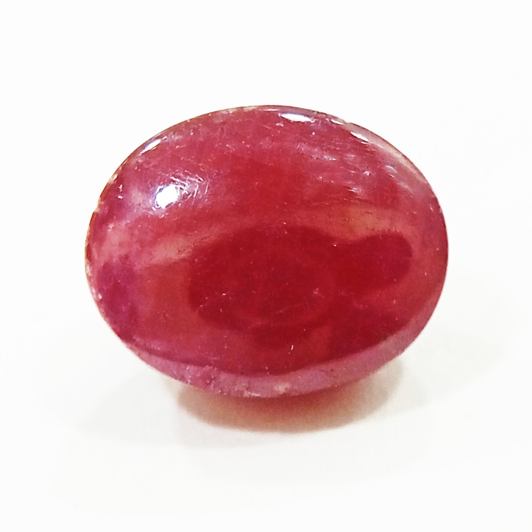 A close-up of a Premium Indian Ruby gemstone showcasing its deep red hue and exceptional clarity.