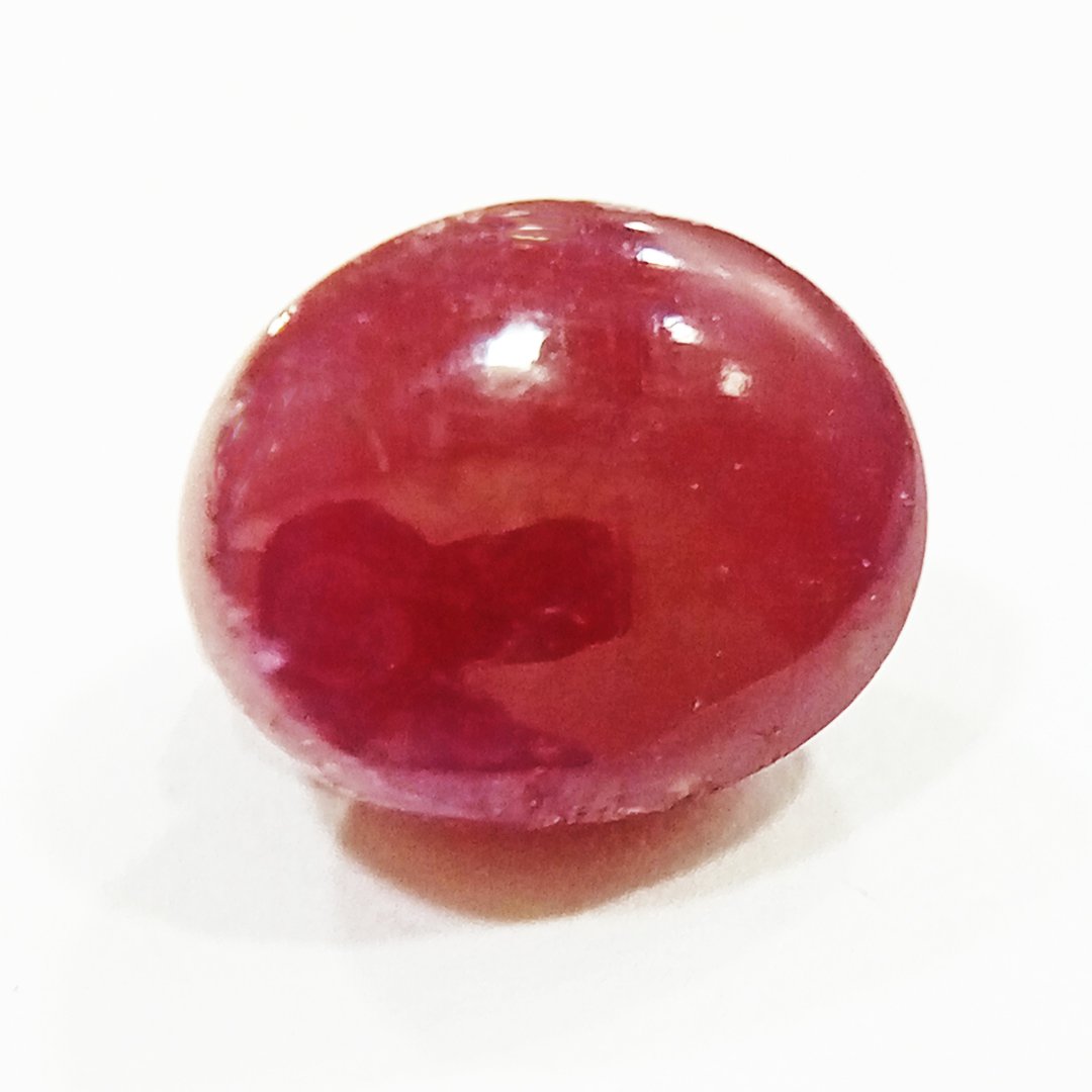 A close-up of a Premium Indian Ruby gemstone showcasing its deep red hue and exceptional clarity.