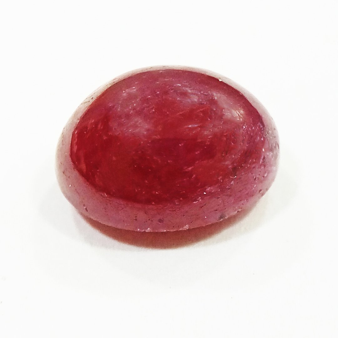 A close-up of a Premium Indian Ruby gemstone showcasing its deep red hue and exceptional clarity.