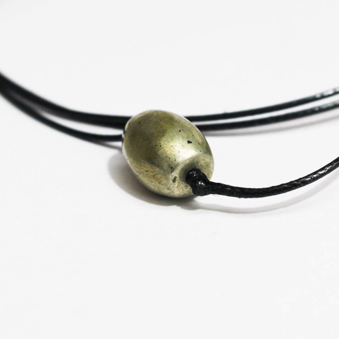 A Parad Pendant – Drum Shape, featuring a smooth metallic finish and spiritual significance.