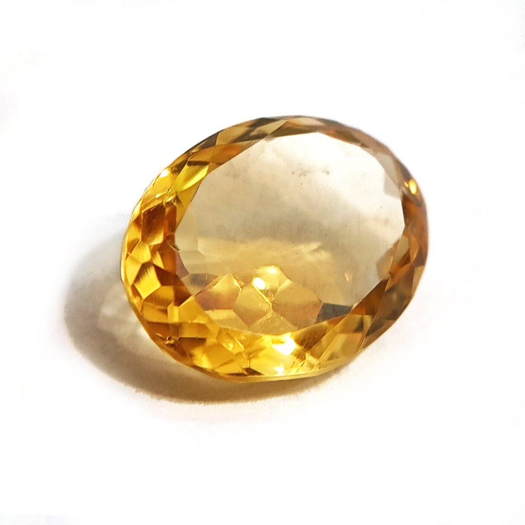 A close-up of a Natural Yellow Citrine gemstone with vibrant golden-yellow hues and sparkling clarity.