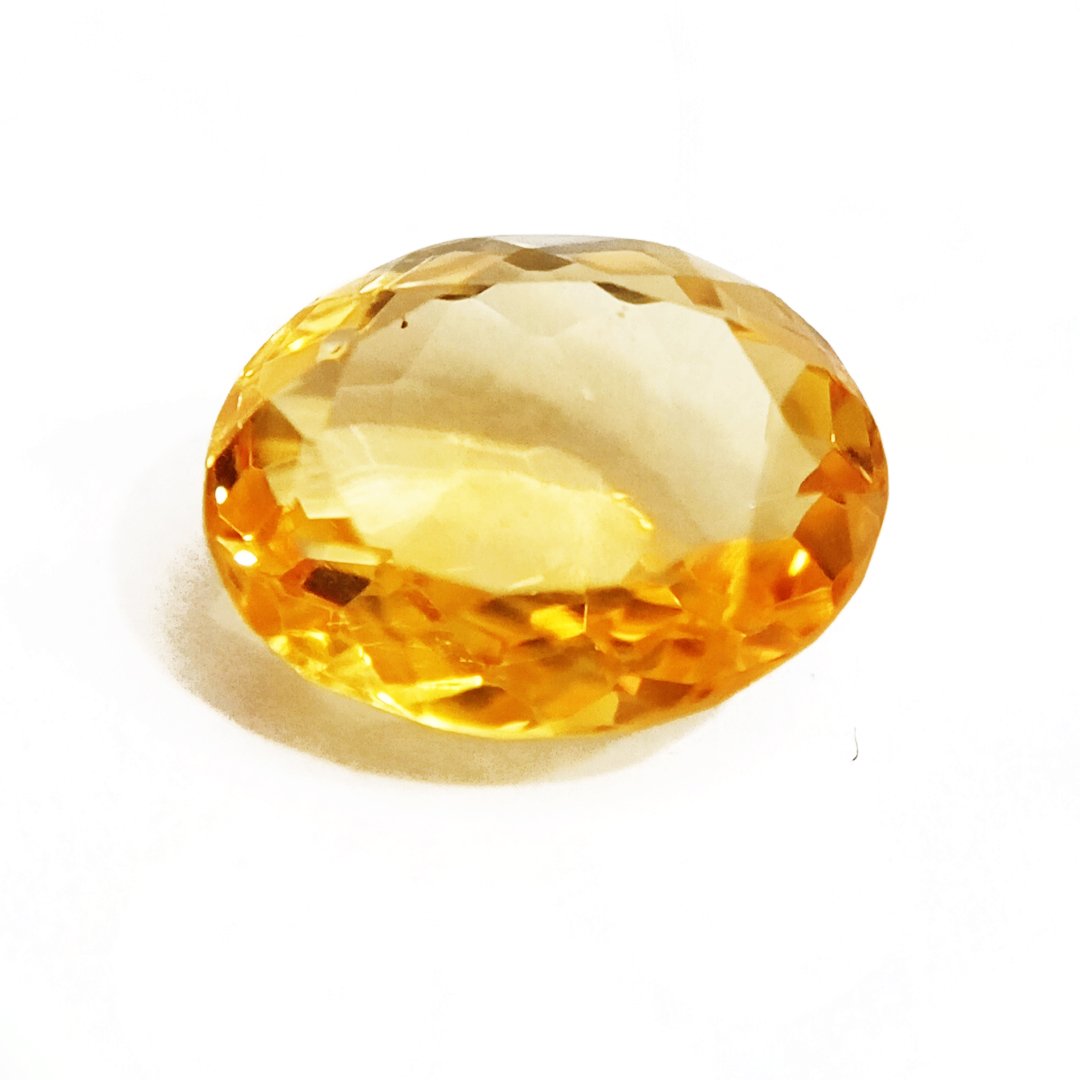 A close-up of a Natural Yellow Citrine gemstone with vibrant golden-yellow hues and sparkling clarity.