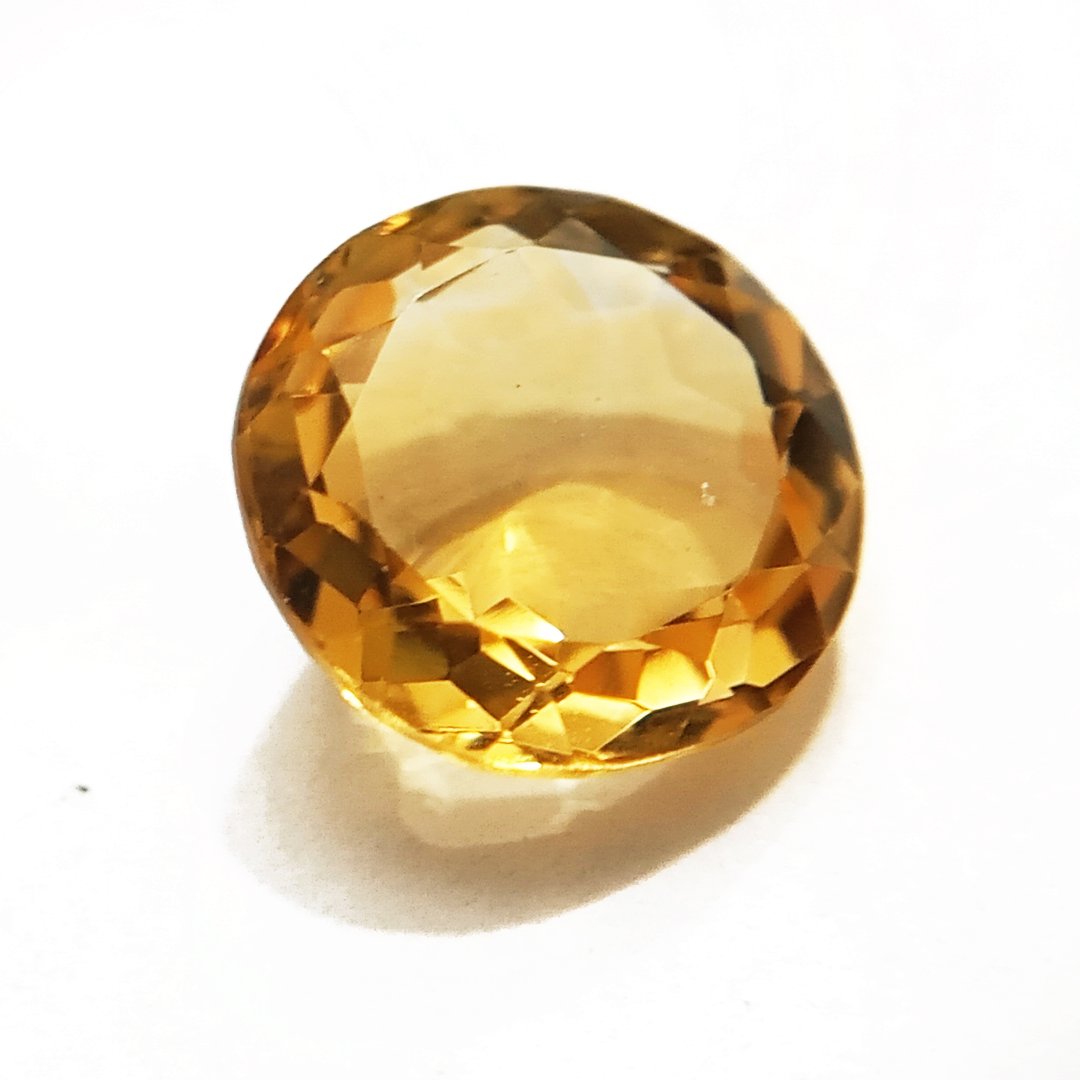 A close-up of a Natural Yellow Citrine gemstone with vibrant golden-yellow hues and sparkling clarity.