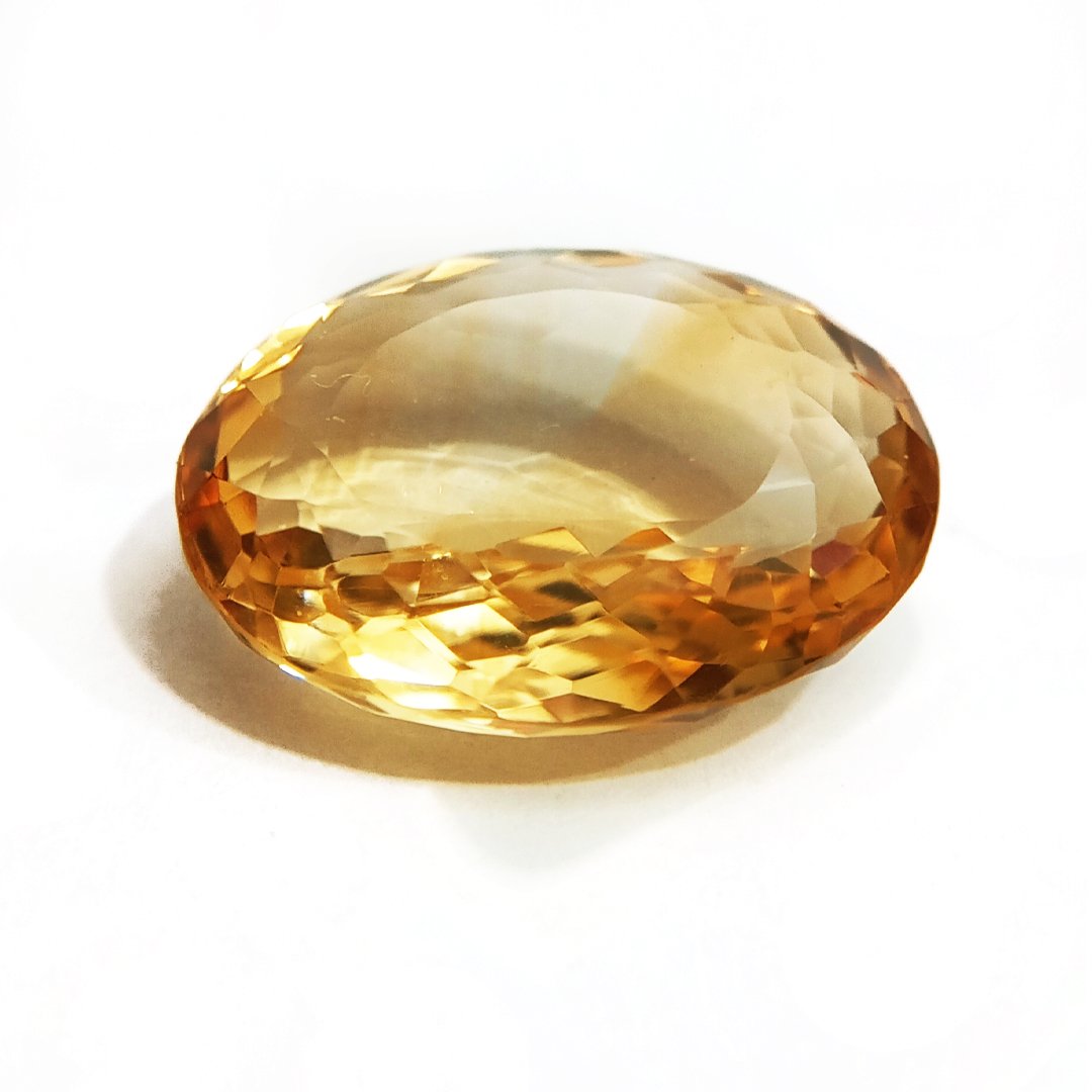 A close-up of a Natural Yellow Citrine gemstone with vibrant golden-yellow hues and sparkling clarity.