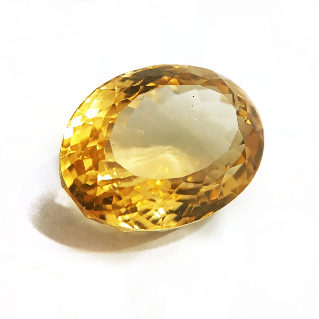 A close-up of a Natural Yellow Citrine gemstone with vibrant golden-yellow hues and sparkling clarity.