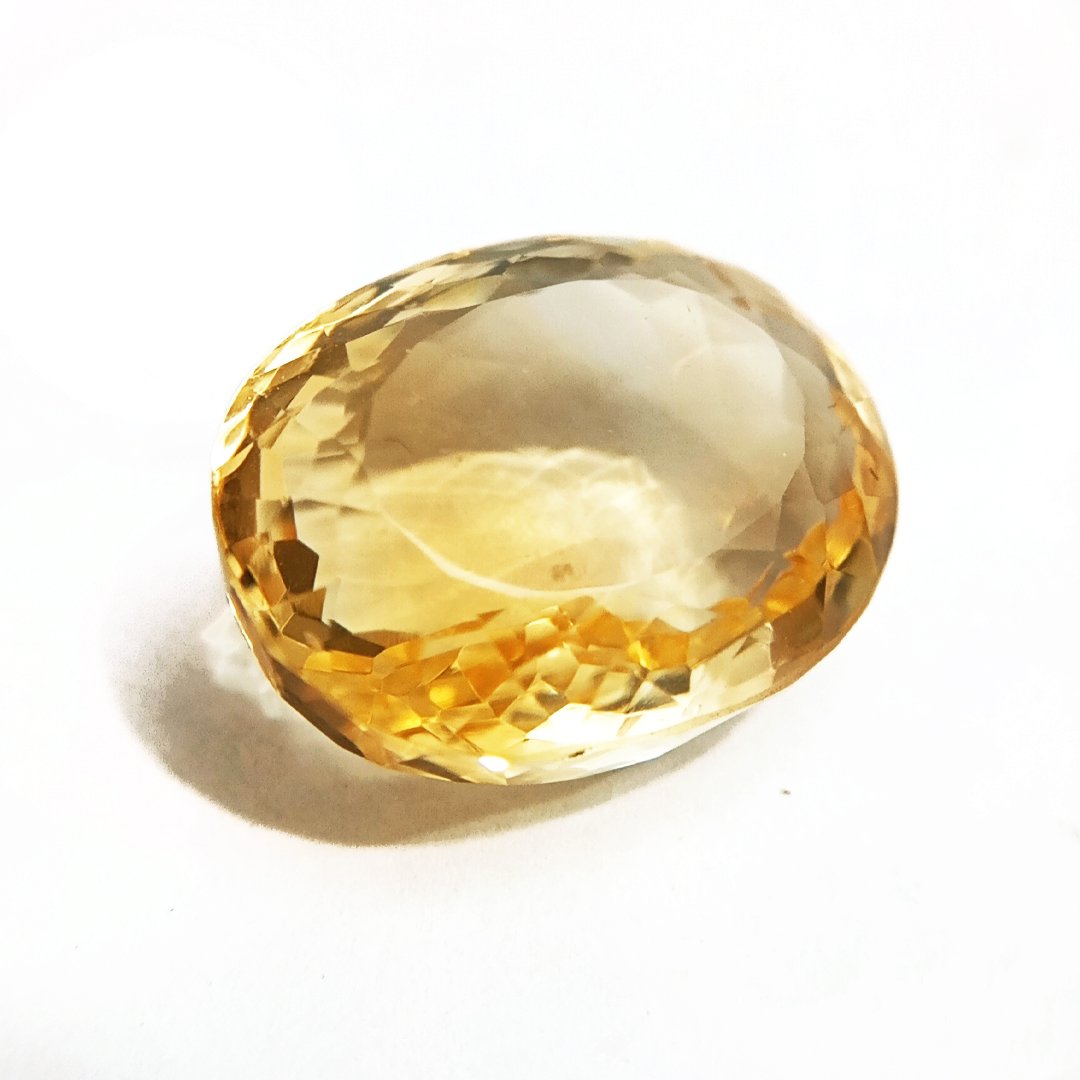 A close-up of a Natural Yellow Citrine gemstone with vibrant golden-yellow hues and sparkling clarity.