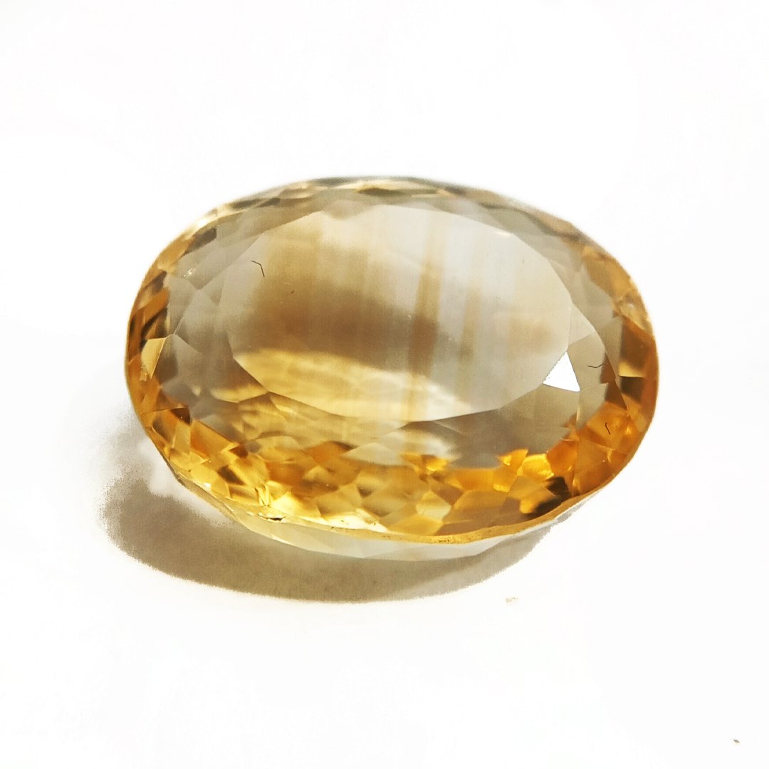 A close-up of a Natural Yellow Citrine gemstone with vibrant golden-yellow hues and sparkling clarity.