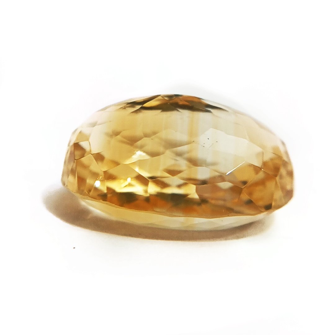 A close-up of a Natural Yellow Citrine gemstone with vibrant golden-yellow hues and sparkling clarity.