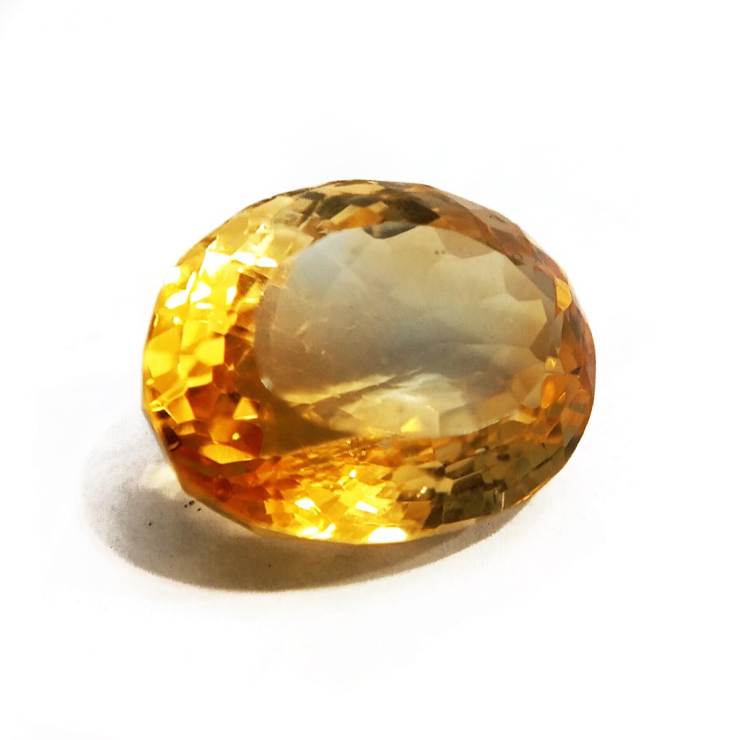 A close-up of a Natural Yellow Citrine gemstone with vibrant golden-yellow hues and sparkling clarity.