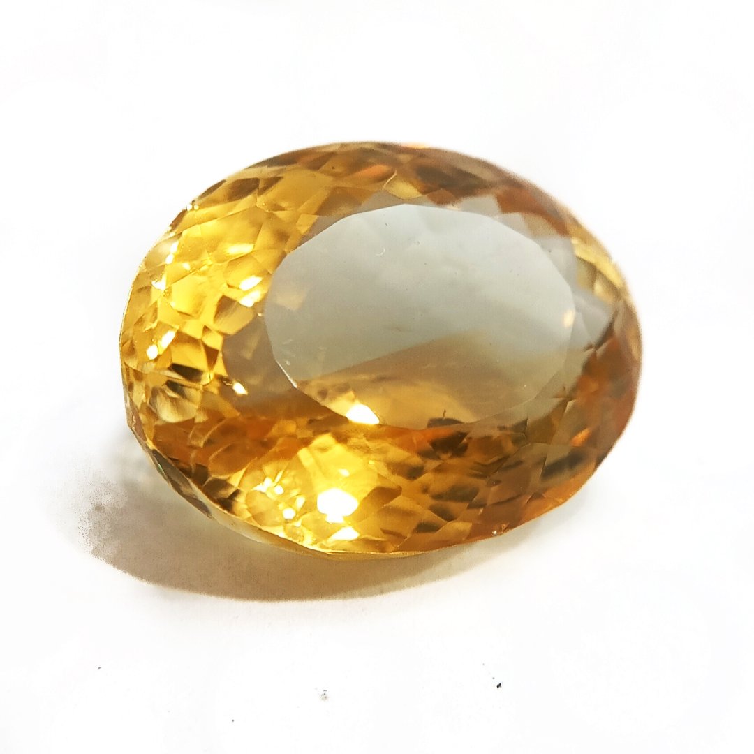 A close-up of a Natural Yellow Citrine gemstone with vibrant golden-yellow hues and sparkling clarity.