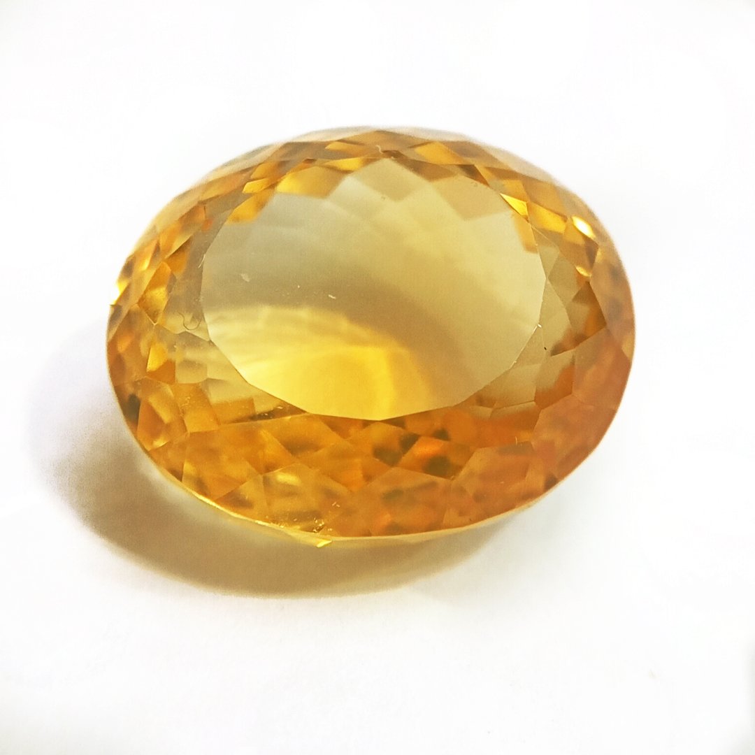 A close-up of a Natural Yellow Citrine gemstone with vibrant golden-yellow hues and sparkling clarity.