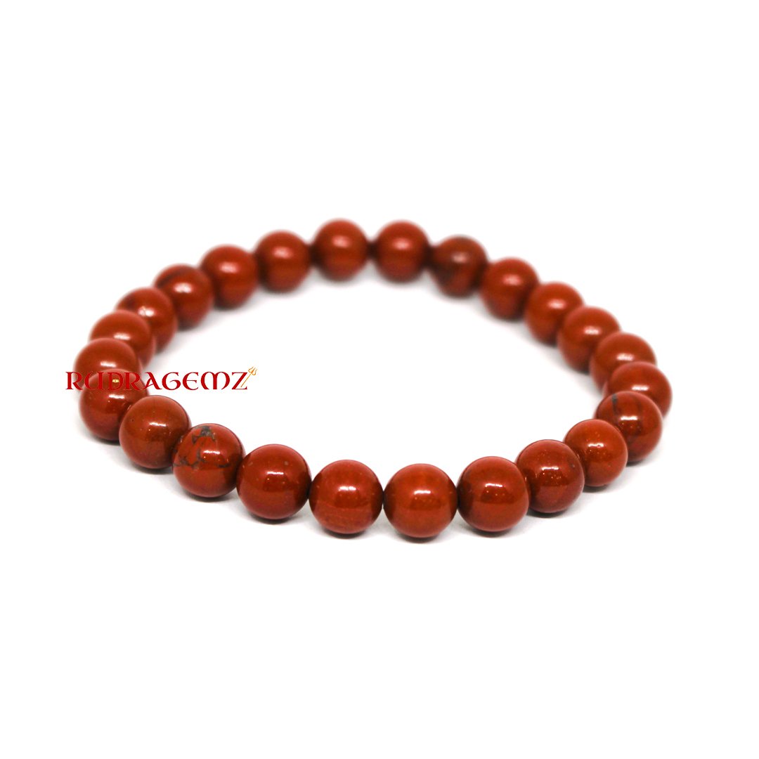 A close-up of a Red Jasper Bracelet featuring polished natural gemstone beads, symbolizing strength and stability.