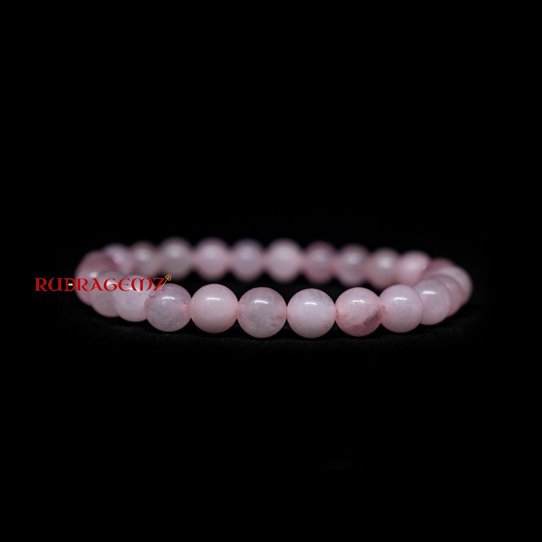 A beautiful Rose Quartz bracelet with smooth, polished beads, radiating soft pink hues, symbolizing love and emotional healing.