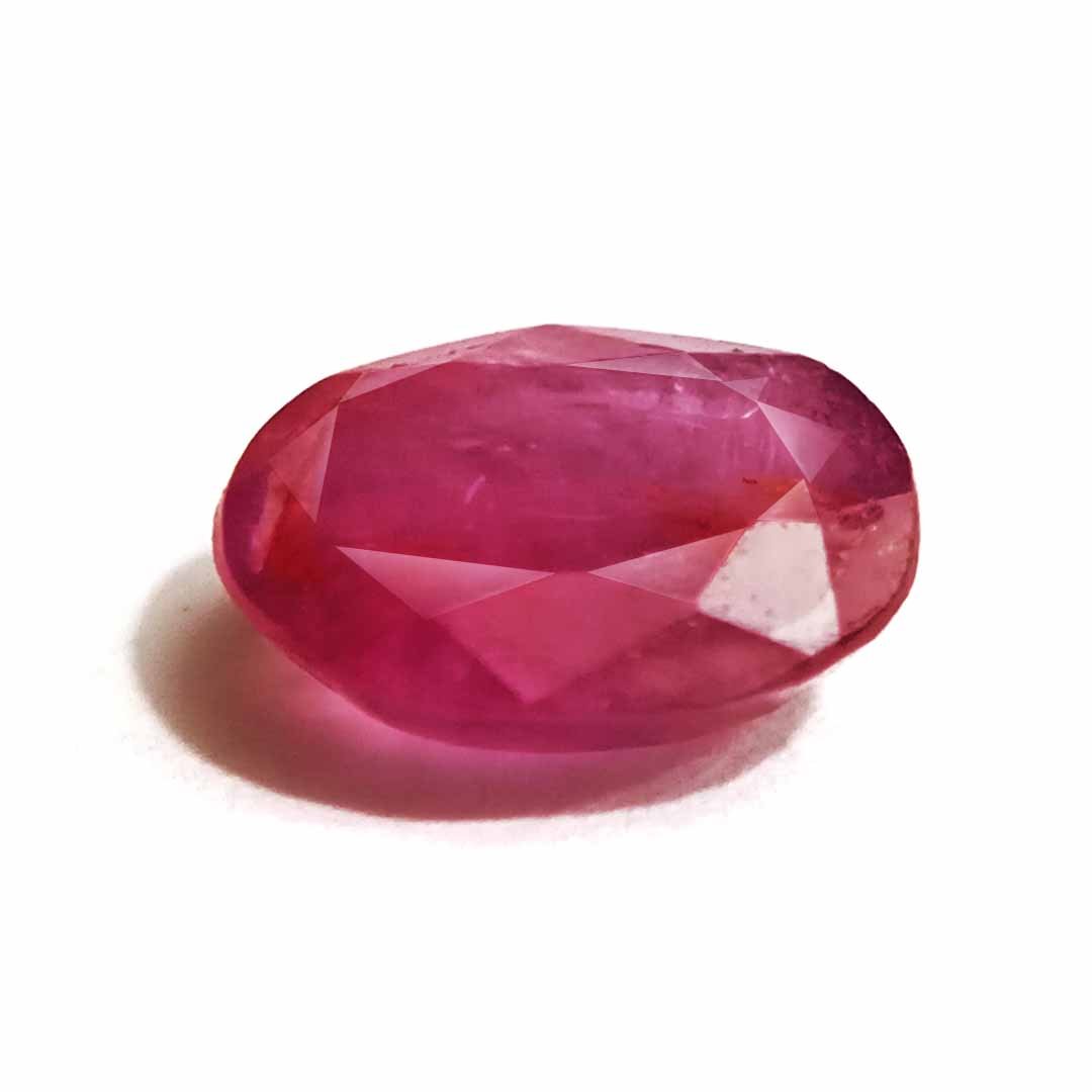 A close-up of a Natural African Ruby gemstone showcasing its rich red hue and brilliant clarity.