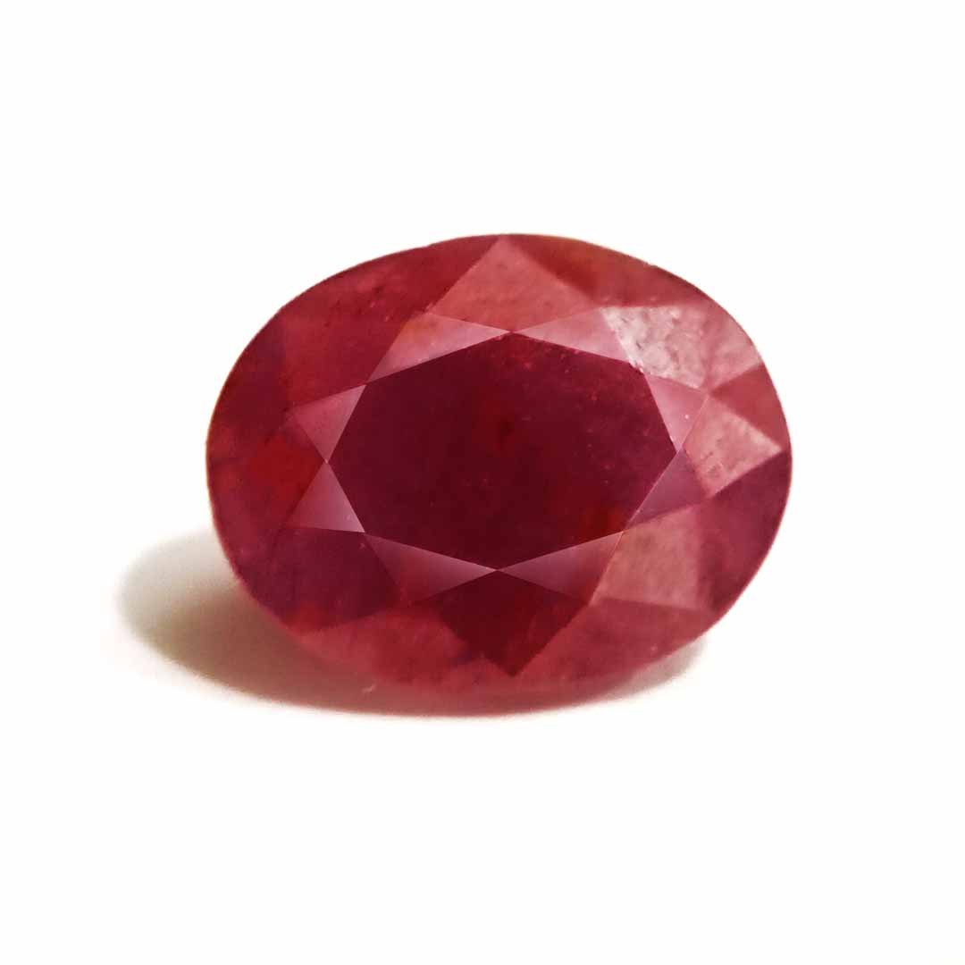 A close-up of a Natural African Ruby gemstone showcasing its rich red hue and brilliant clarity.