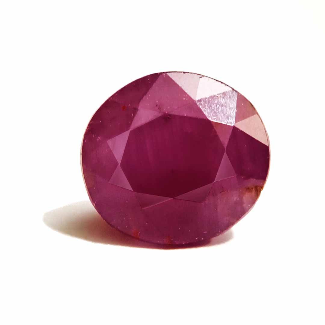 A close-up of a Natural African Ruby gemstone showcasing its rich red hue and brilliant clarity.