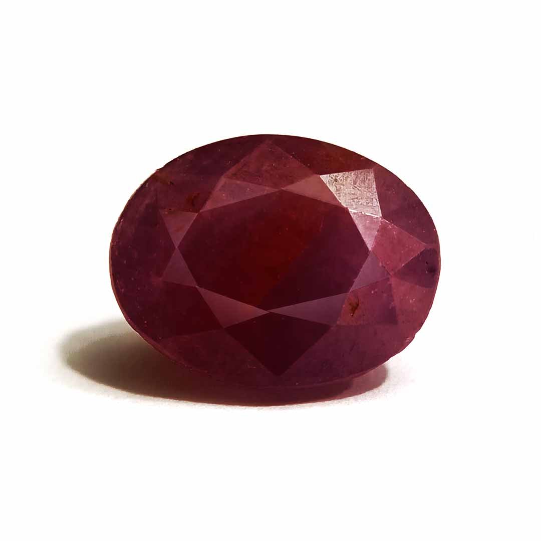 A close-up of a Natural African Ruby gemstone showcasing its rich red hue and brilliant clarity.