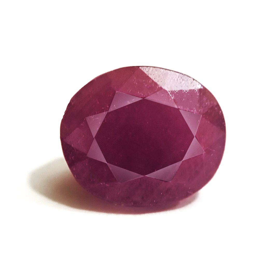 A close-up of a Natural African Ruby gemstone showcasing its rich red hue and brilliant clarity.